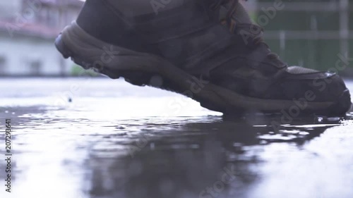 Foot with Outdoor Shoe Stepping into Puddle and Splashing Water SlowMo 100 FPS