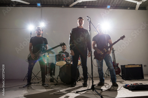 Obraz na plátne Portrait of a rock band on stage ready to play