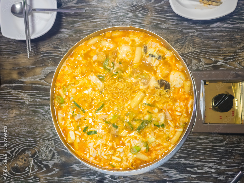Cheesy Tokbokki korean traditional food on wood background. Cheesy Tokbokki korean traditional food on wood background.