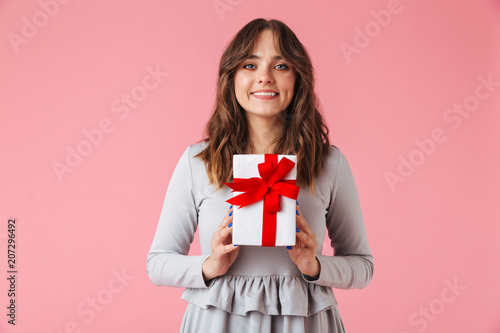 Cute young pretty woman holding surprise gift present box.