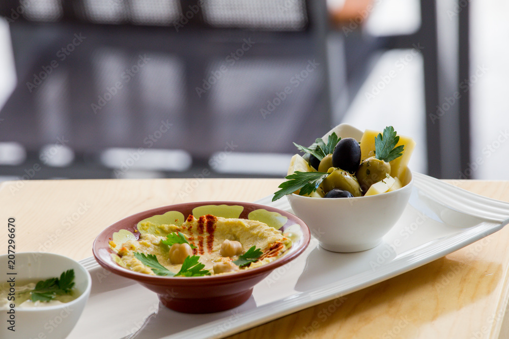 Traditional Arabic breakfast, lettuce, eggs, cheese, olives, and decorative vegetables, served on a plate, restaurant, service Traditional Arabic breakfast, lettuce, eggs, cheese, olives, and decorative vegetables, served on a plate, restaurant, service