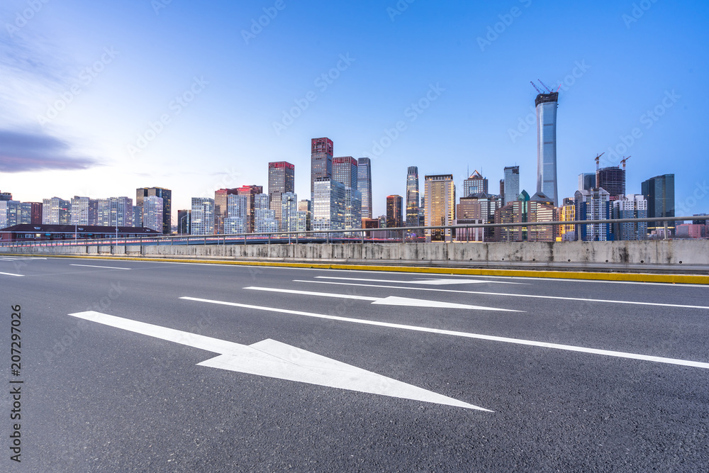 city skyline with empty asphalt road in urban