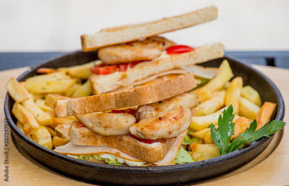 Chicken sandwich in toast bread, with French fries as a bowl, on a white background, restaurant, served Chicken sandwich in toast bread, with French fries as a bowl, on a white background, restaurant, served