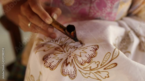 Detail of waxing the drawing to textile for making batik. Bali island.