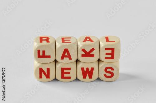 Words Fake and Real News written with wood cubes