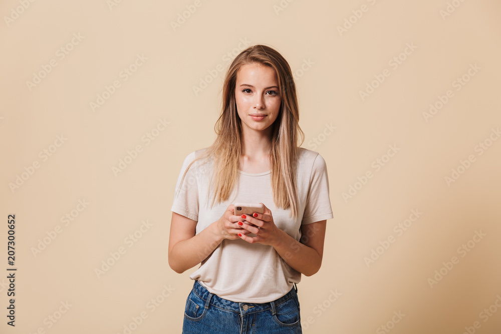 Portrait of a pretty casual girl holding mobile phone Portrait of a pretty casual girl holding mobile phone