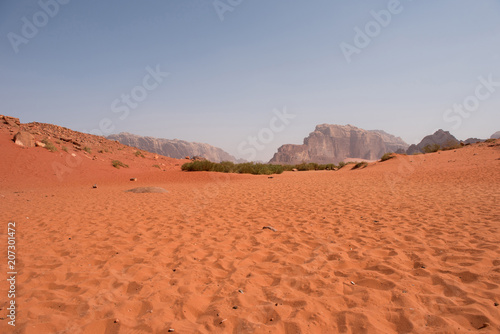 Red sand dunes and sandstone cliffs