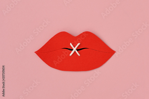 Bilde på lerret Paper lips cut-out sewn with white thread - Violence against women concept