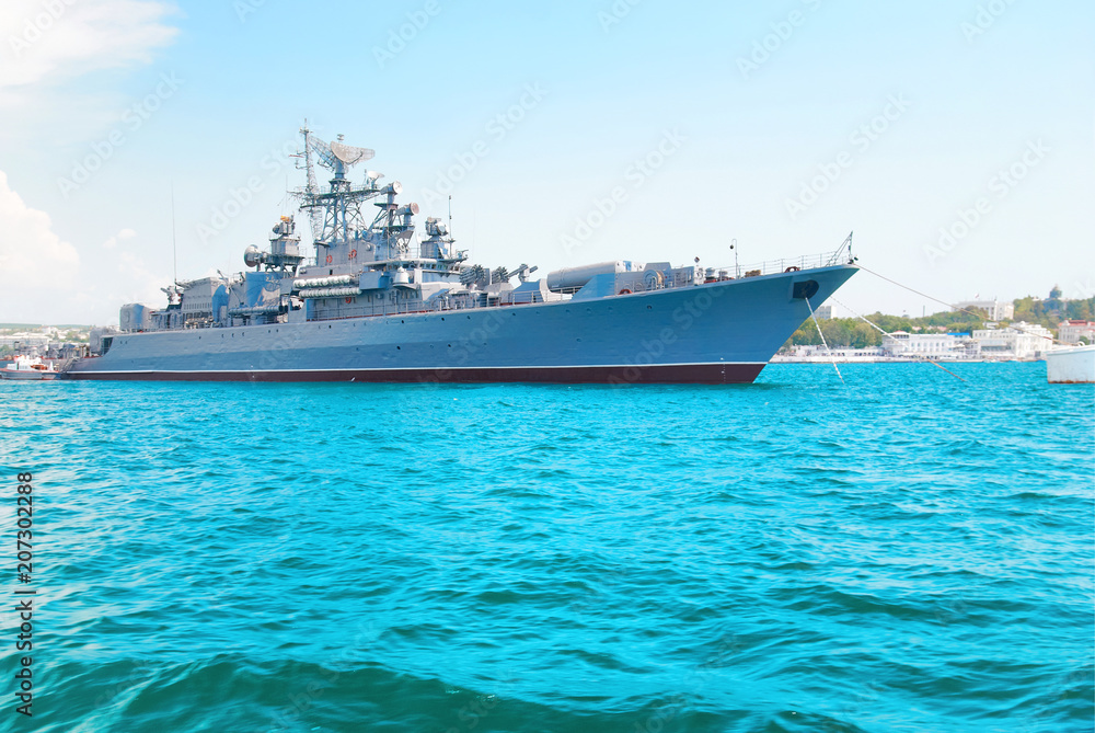 Military navy ship in blue sea with sky and clouds Military navy ship in blue sea with sky and clouds