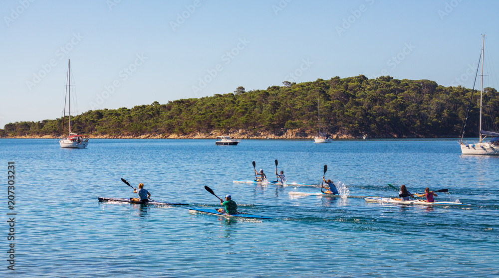 Naklejka premium Rowing training at the sea of a group of teenager