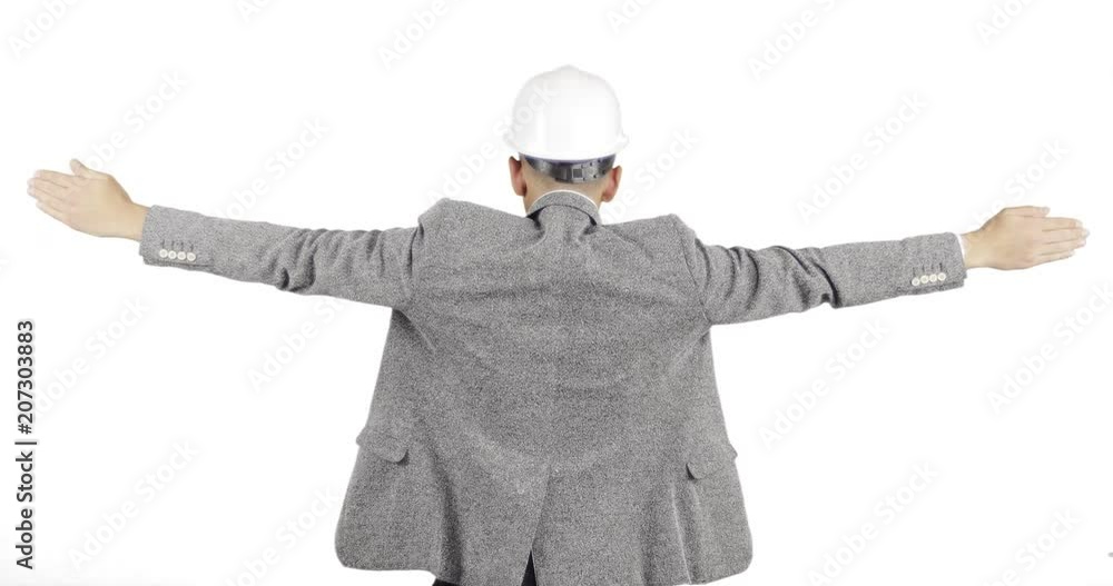 The builder in the helmet raises his hands up and keeps his balance.