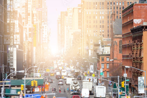 Sunlight shines down the busy streets of Chelsea in Manhattan, New York City NYC