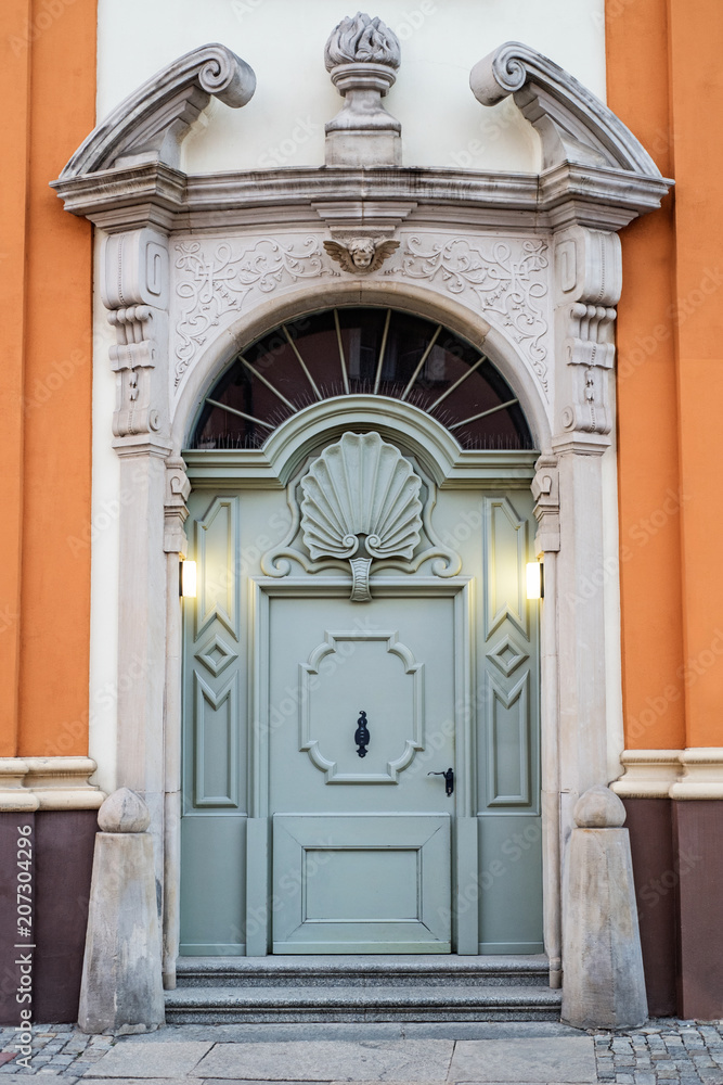 old blue door with arch in the Baroque style