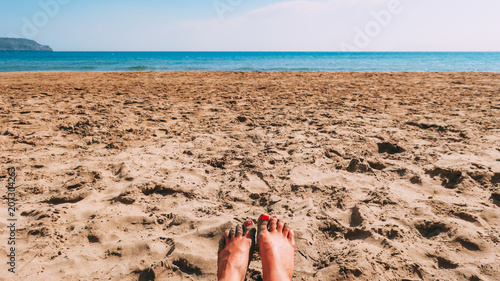 A woman's feet in the sand ...