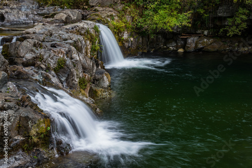 Fototapeta Naklejka Na Ścianę i Meble -  Waterfalls flow over rocks in the woods