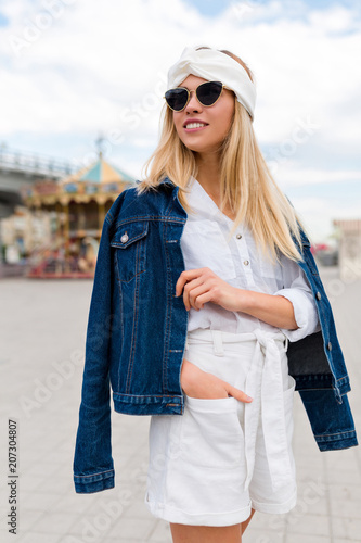 Obraz na płótnie Summer time in big city of adorable woman walking on street dressed jacket and white suit with glasses. Expressing positivity, smiling to camera, joyful cheerful mood, true emotions, vacation w salonie
