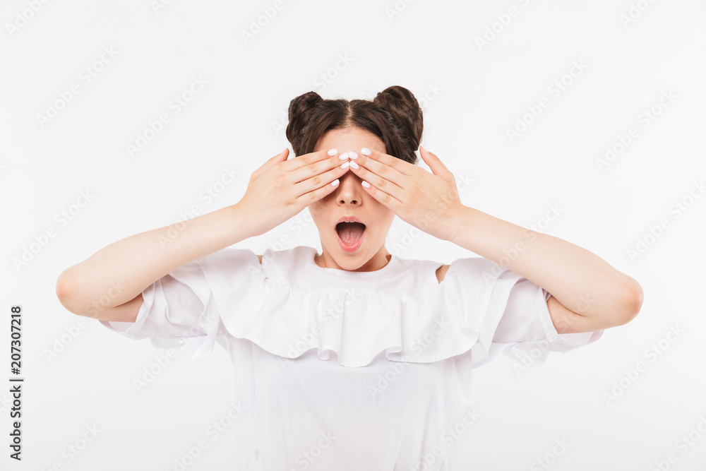Photo of positive teenage woman with double buns hairstyle and dental braces screaming in surprise and covering eyes with hands, isolated over white background Photo of positive teenage woman with double buns hairstyle and dental braces screaming in surprise and covering eyes with hands, isolated over white background
