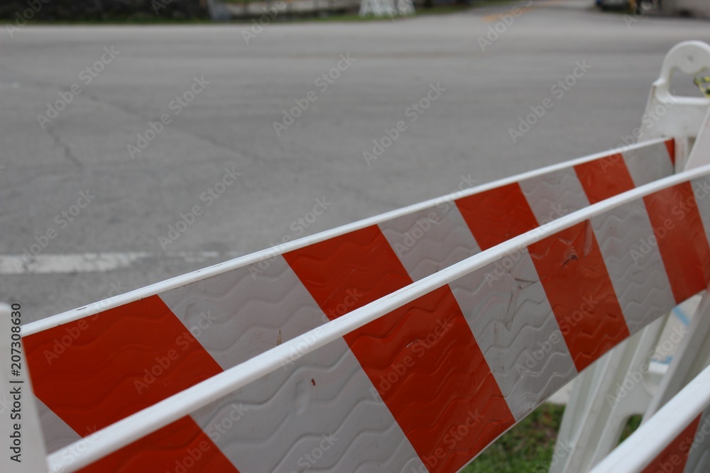 group of plastic orange and white a-frame traffic barriers