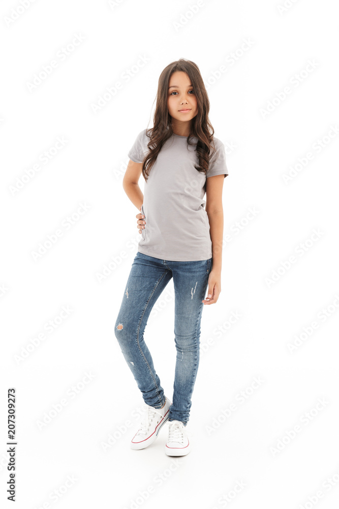 Girl standing posing isolated over white wall background. Girl standing posing isolated over white wall background.