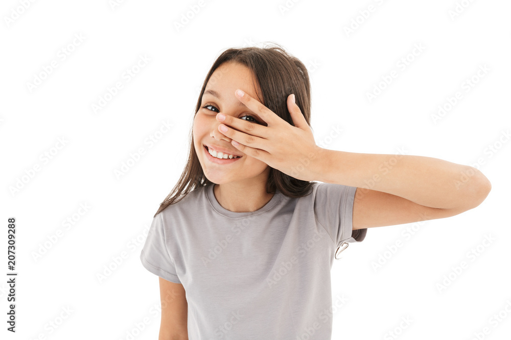 Cute girl covering eyes with hands looking camera. Cute girl covering eyes with hands looking camera.