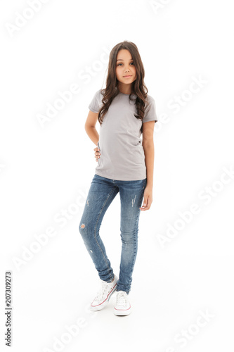 Girl standing posing isolated over white wall background.