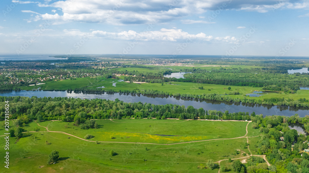 Obraz premium Aerial top view of Kyiv cityscape, Dnieper and Dniester river, green island from above, Kiev city skyline and nature parks in spring, Ukraine 