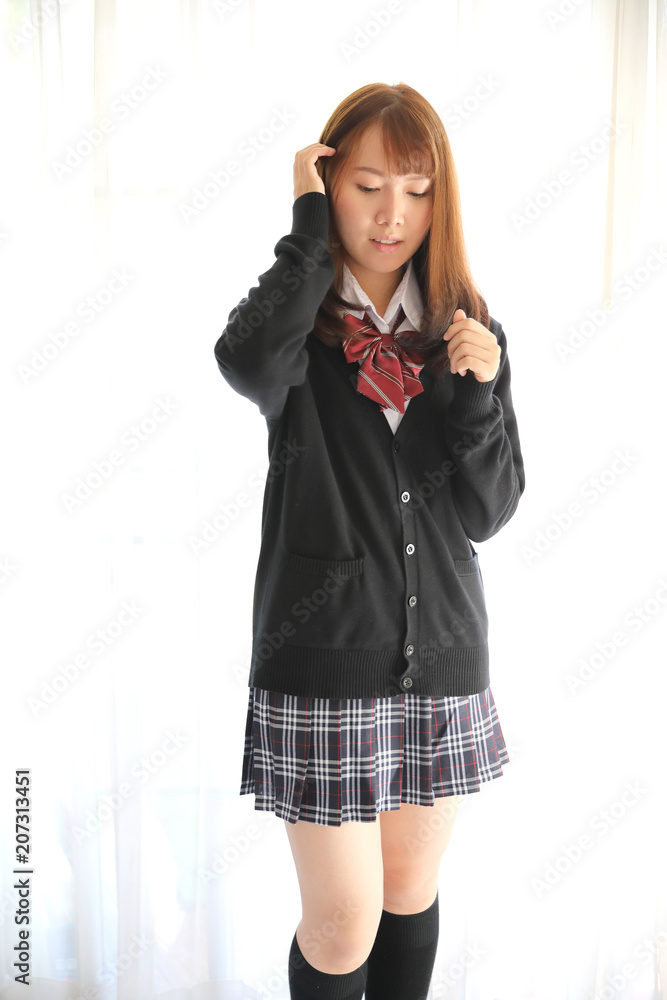 Fototapeta premium Portrait japanese school girl in white tone bed room