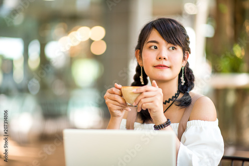 Asian women Working laptop with coffee select focus.