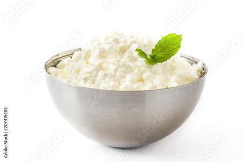 Fresh cottage cheese in a metal bowl isolated on white background. 