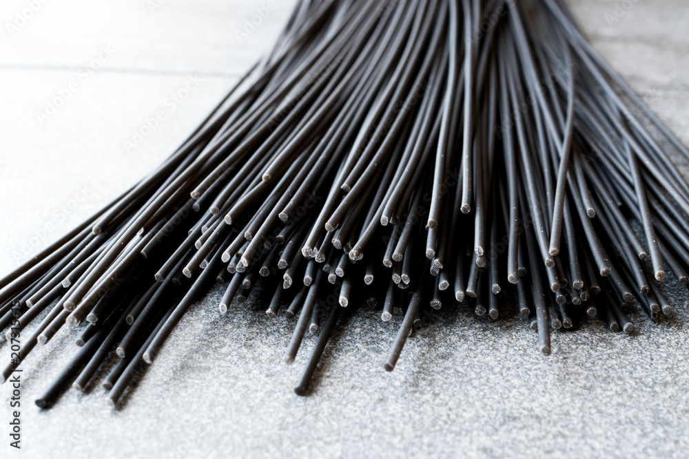 Raw Black Spaghetti Pasta Flavored with Squid ink or Cuttlefish. Raw Black Spaghetti Pasta Flavored with Squid ink or Cuttlefish.