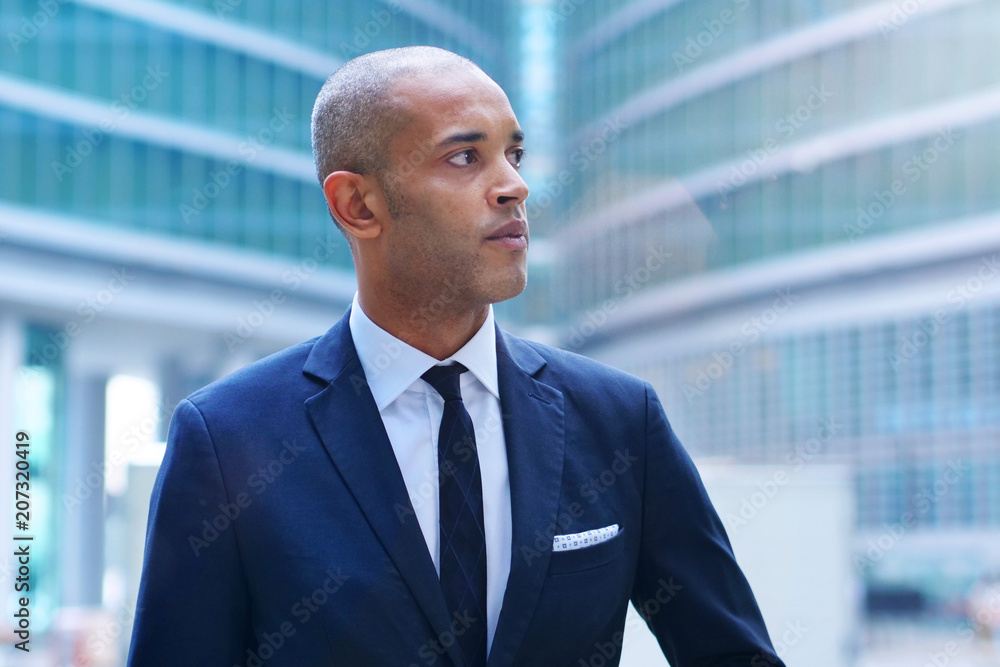 Portrait of a business man, in a suit and tie, happy and smiling as he looks at the camera and crosses his arms, proud of his work. Concept of: technology, network, success, finance. Portrait of a business man, in a suit and tie, happy and smiling as he looks at the camera and crosses his arms, proud of his work. Concept of: technology, network, success, finance.