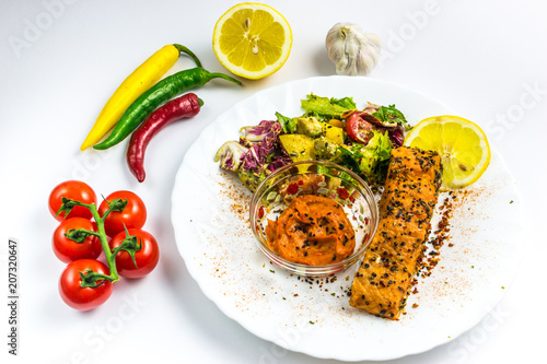 Salmon with vegetabes on white plate photo