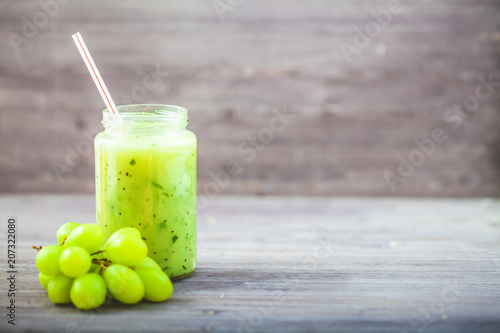 freshly squeezed fruit juice, smoothies greengrape strawberry on a dark wooden background Copy space photo