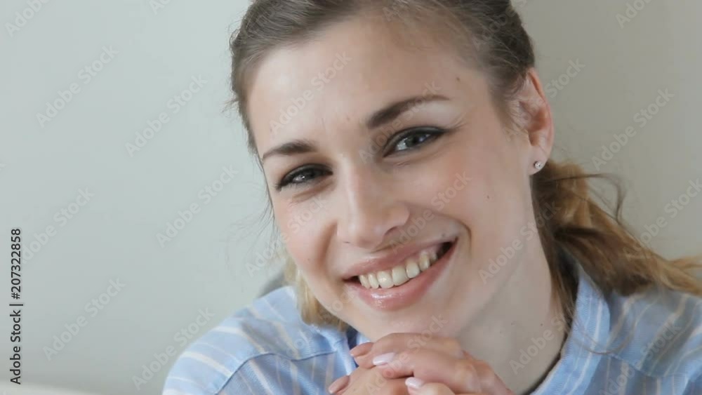 Crop close-up view of beautiful female indoors looking seriously then smile Crop close-up view of beautiful female indoors looking seriously then smile