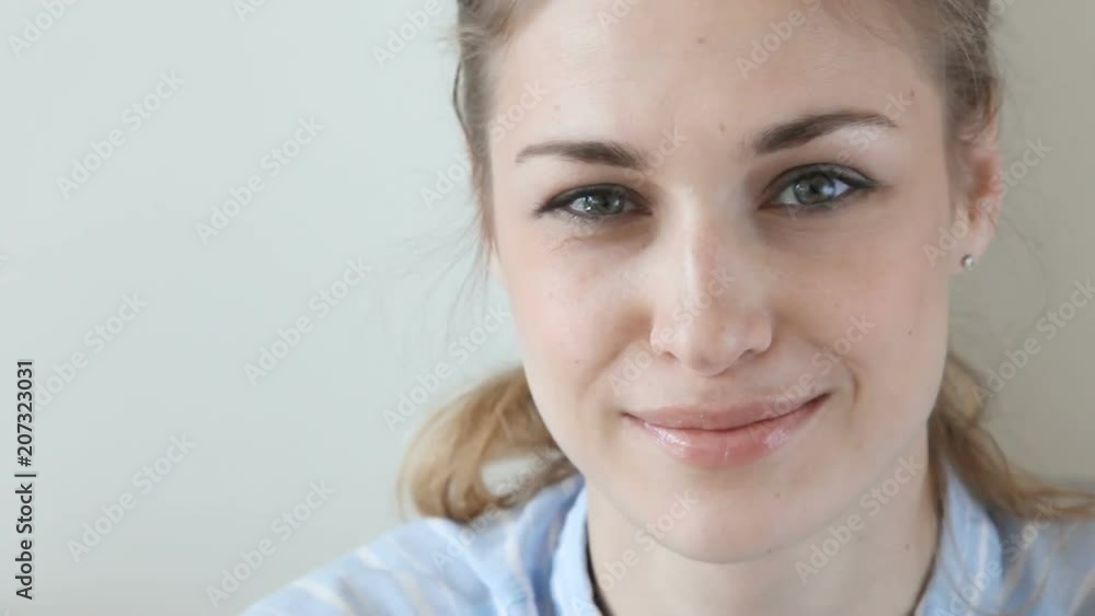 Crop close-up view of beautiful female indoors looking seriously then smile Crop close-up view of beautiful female indoors looking seriously then smile