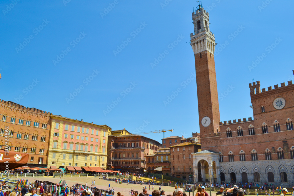 Piazza del Campo with the Palazzo Pubblico (town hall) and Torre del Mangia at background in Siena, Italy