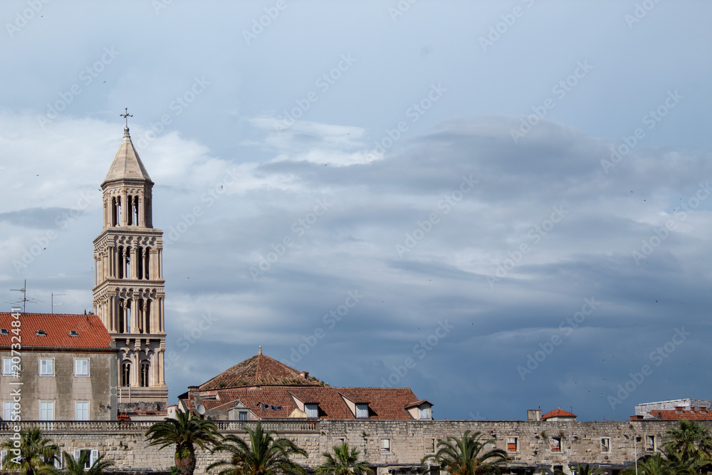 A old tower with cloudy sky in the background.