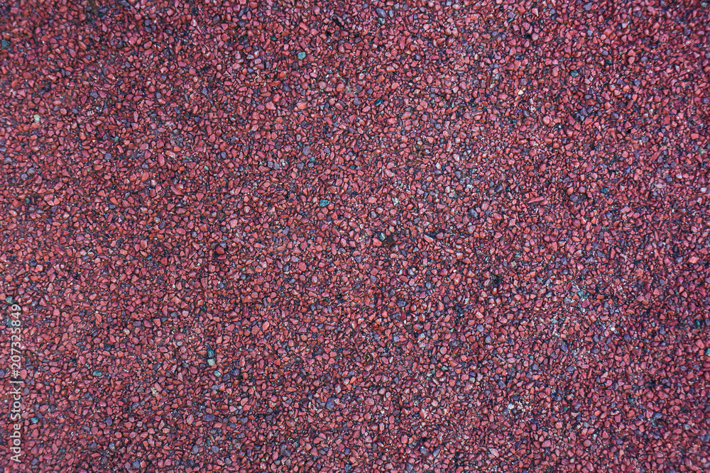 grainy red surface, background with small stones grainy red surface, background with small stones