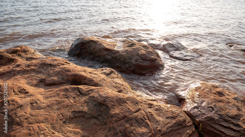 rocks in lake with writing on them