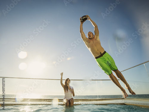 Couple playing football in swimming pool
