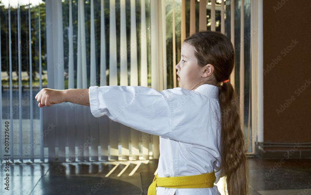 A good sportswoman trains a punch with her hand A good sportswoman trains a punch with her hand