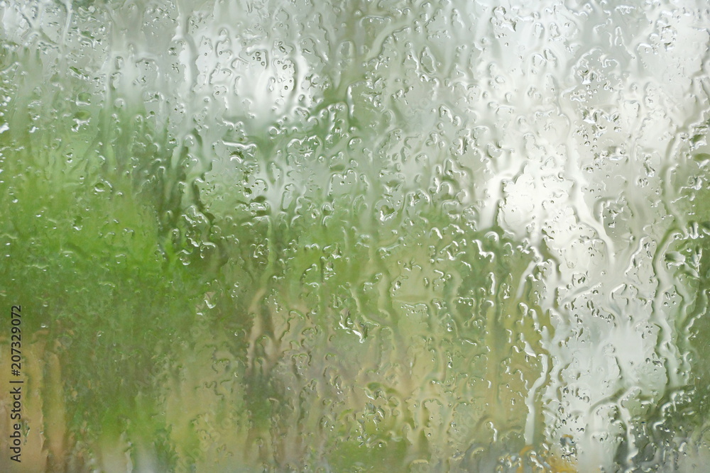 the rain outside the window. rain drops on glass spring or autumn the rain outside the window. rain drops on glass spring or autumn