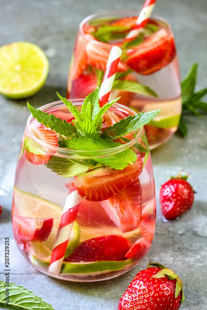 fresh lemonade with strawberries , lime and mint on a wooden background fresh lemonade with strawberries , lime and mint on a wooden background