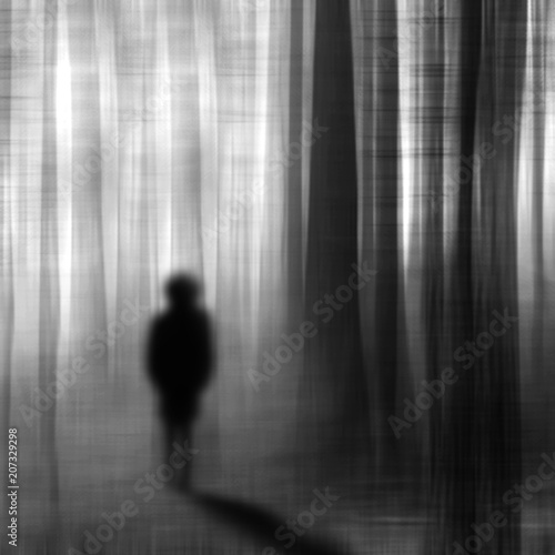 Surreal man walking in the forest at night.