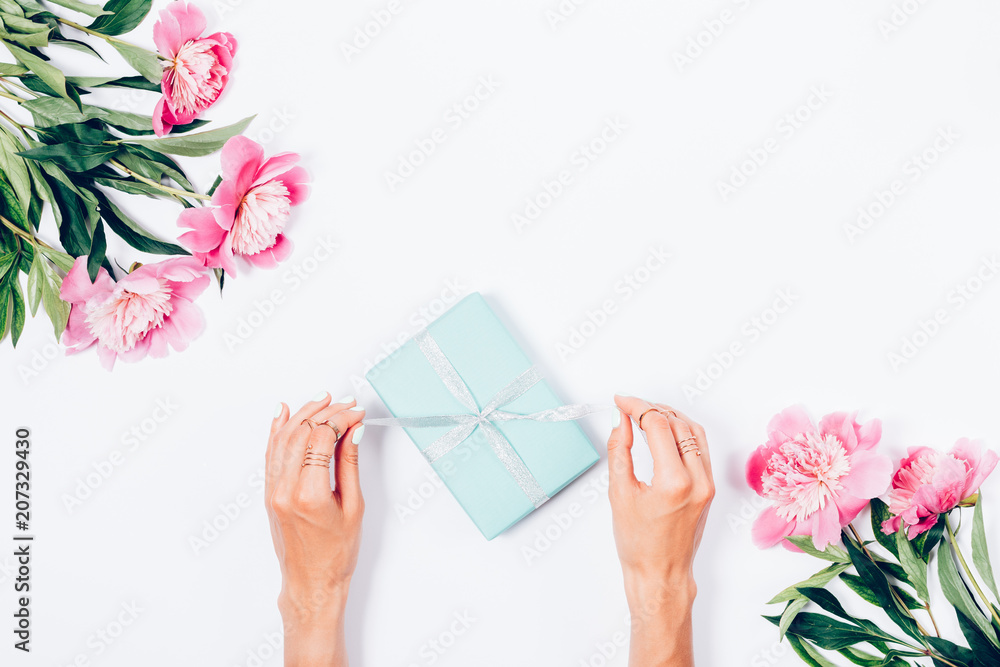 Woman opening her present, top view Woman opening her present, top view