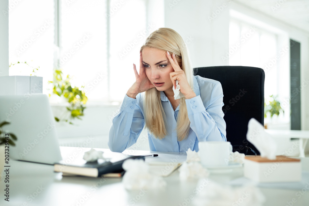 Young businesswoman suffering flu at work Young businesswoman suffering flu at work