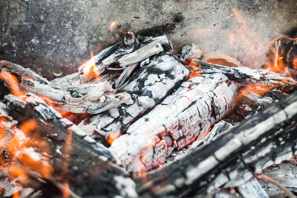 The hot coals with the tongues of flame in the old grill The hot coals with the tongues of flame in the old grill