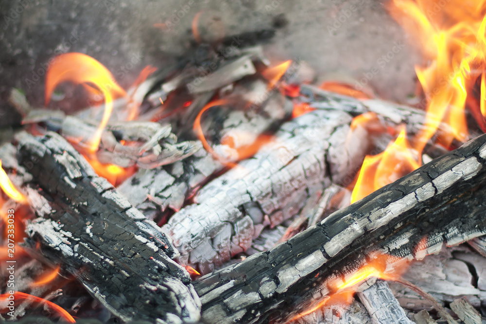 The hot coals with the tongues of flame in the old grill The hot coals with the tongues of flame in the old grill