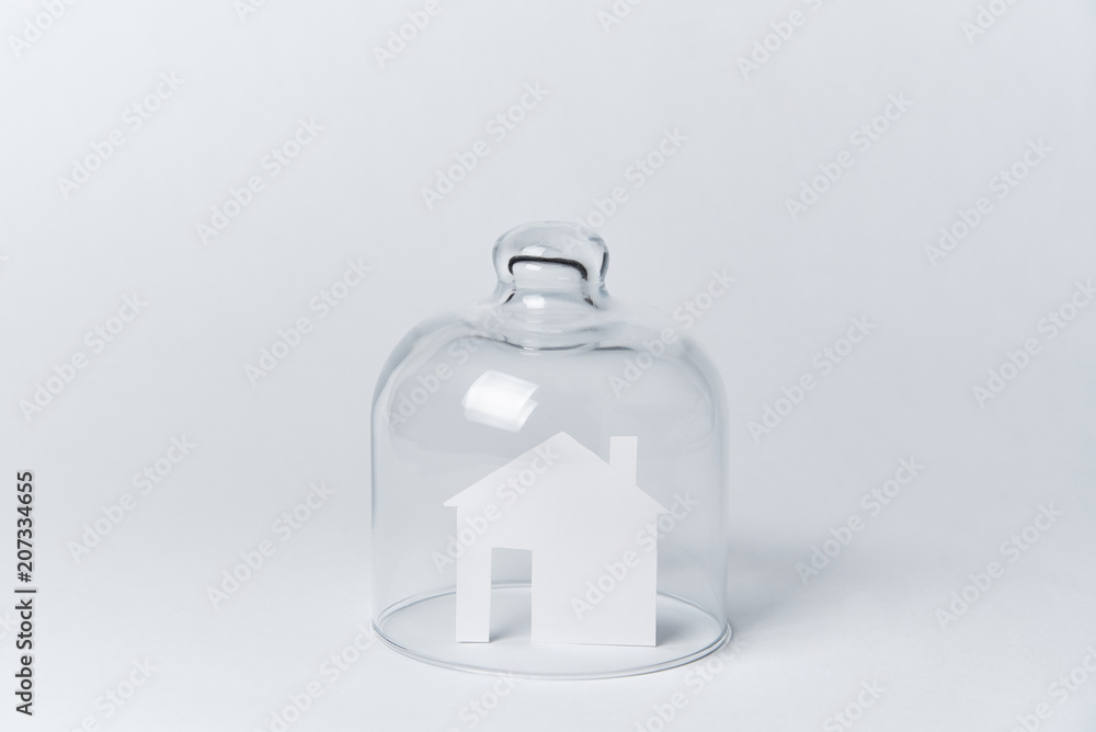 Obraz premium A house made of white paper under glass on a white background.