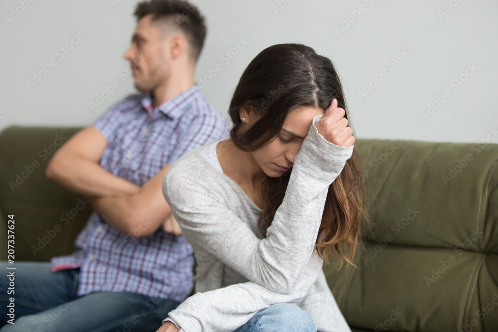 Depressed frustrated millennial woman feeling offended and sad after fight with stubborn selfish husband sitting on couch, unhappy young wife tired of bad relationships, upset about marriage problems Depressed frustrated millennial woman feeling offended and sad after fight with stubborn selfish husband sitting on couch, unhappy young wife tired of bad relationships, upset about marriage problems